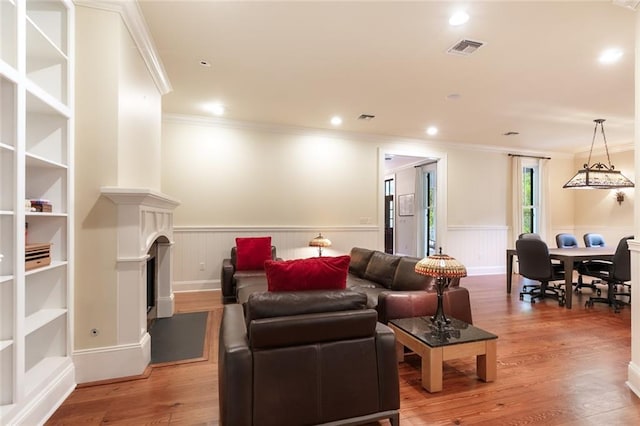 living room with crown molding and wood-type flooring