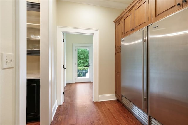 kitchen featuring dark wood-type flooring and built in fridge