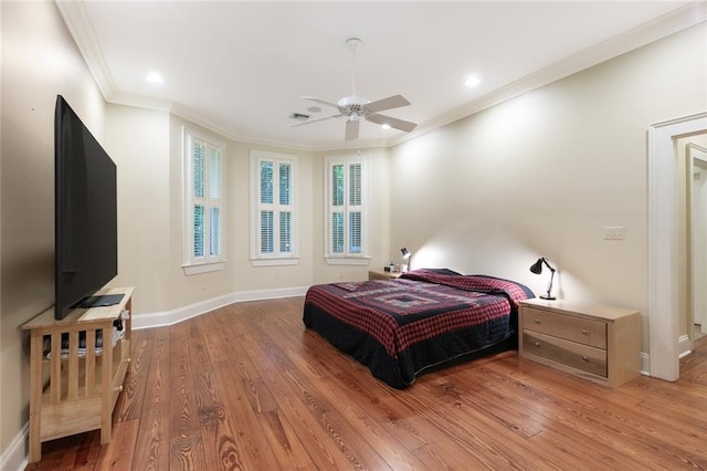 bedroom with ceiling fan, hardwood / wood-style flooring, and ornamental molding