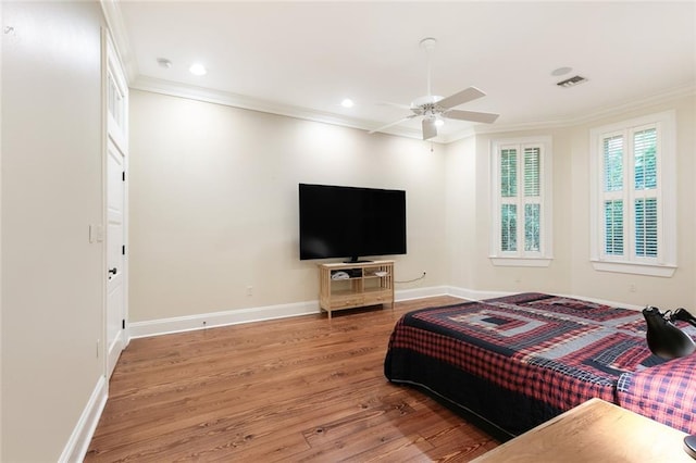 bedroom with ceiling fan, crown molding, and light hardwood / wood-style flooring