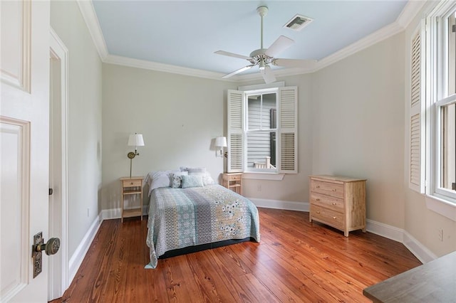 bedroom featuring ceiling fan, wood-type flooring, and ornamental molding