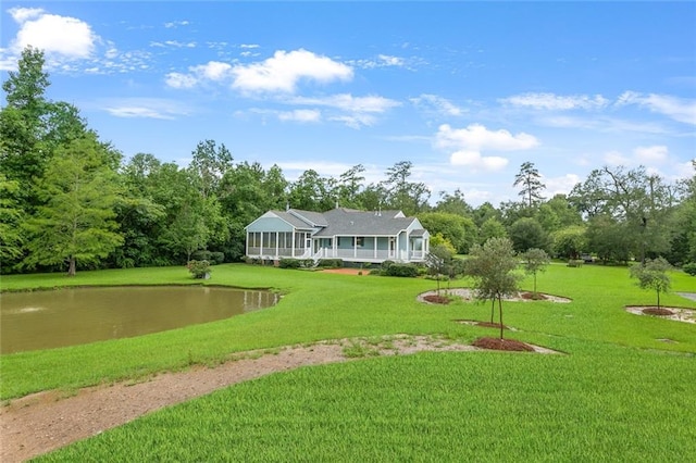 view of home's community featuring a water view and a yard