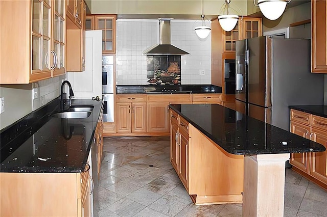 kitchen with wall chimney exhaust hood, sink, a kitchen island, pendant lighting, and stainless steel appliances