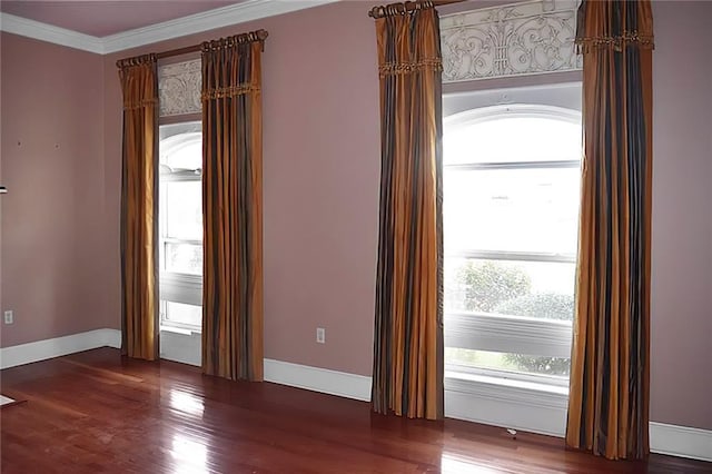 spare room featuring ornamental molding and hardwood / wood-style floors