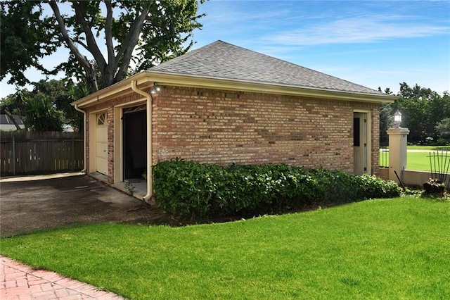 view of side of home featuring a yard and a garage