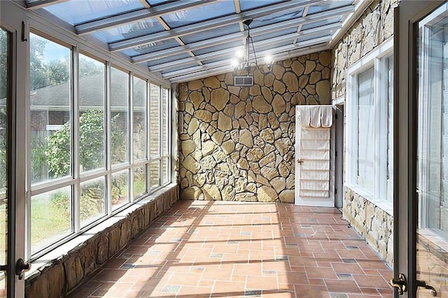 unfurnished sunroom with a chandelier