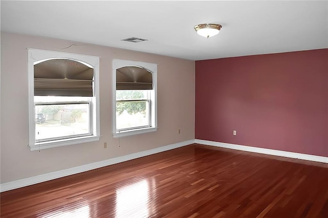 empty room with hardwood / wood-style floors