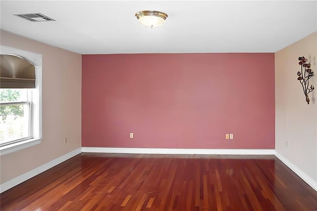 unfurnished room with dark hardwood / wood-style flooring