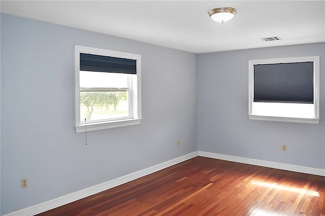 unfurnished room featuring dark hardwood / wood-style flooring