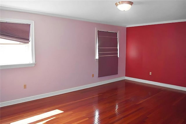 spare room featuring crown molding and wood-type flooring