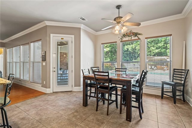 dining area featuring light tile patterned floors and ornamental molding