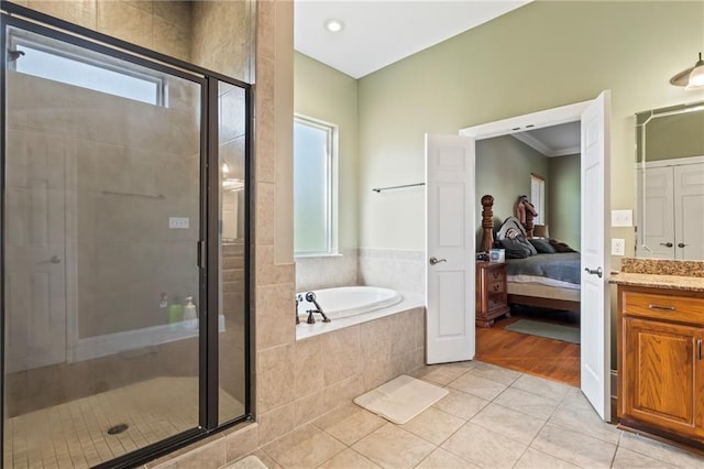 bathroom with independent shower and bath, hardwood / wood-style floors, vanity, and ornamental molding