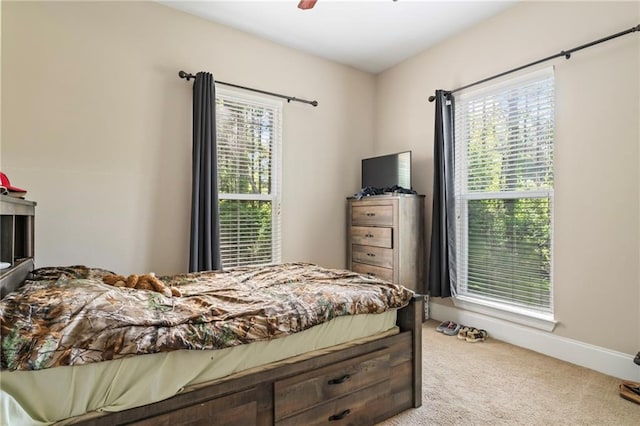 carpeted bedroom featuring ceiling fan