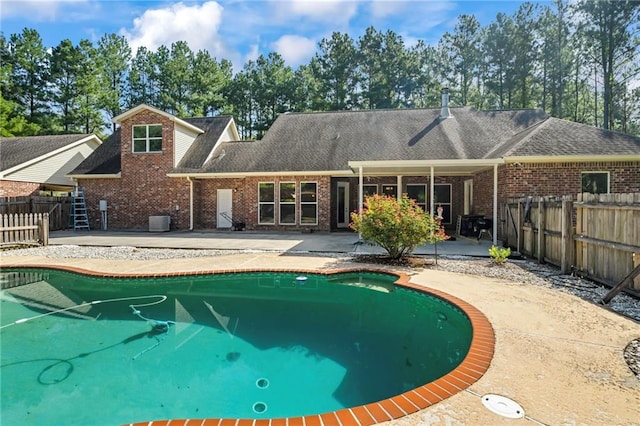 view of pool featuring central air condition unit and a patio area