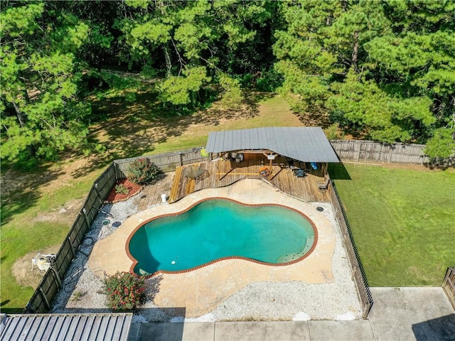 view of swimming pool with a deck and a lawn