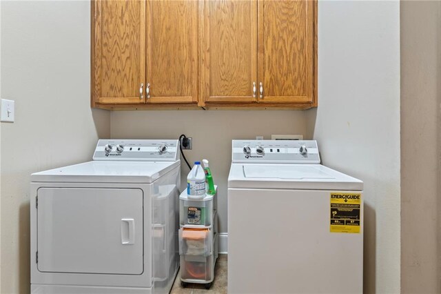 laundry room featuring cabinets, washing machine and dryer, and light tile patterned flooring