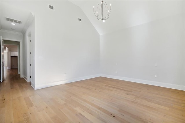 spare room featuring vaulted ceiling, ornamental molding, a chandelier, and light hardwood / wood-style floors