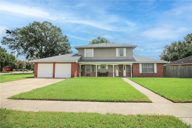 front of property with a garage and a front lawn