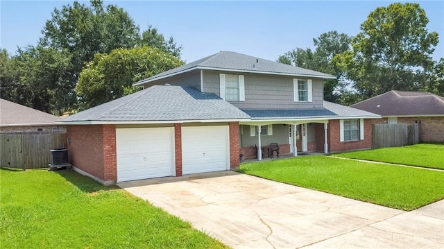 front of property featuring cooling unit, a garage, and a front lawn