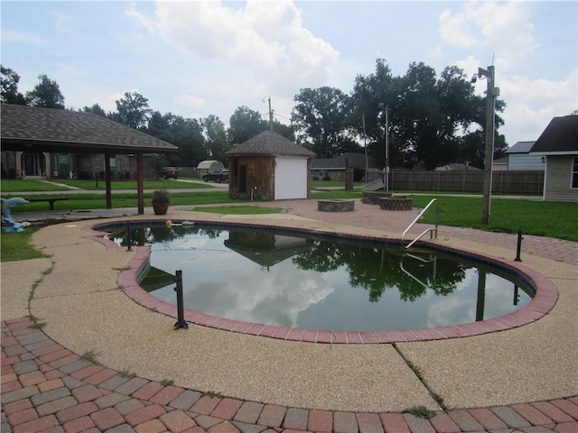 view of swimming pool featuring a patio and a lawn