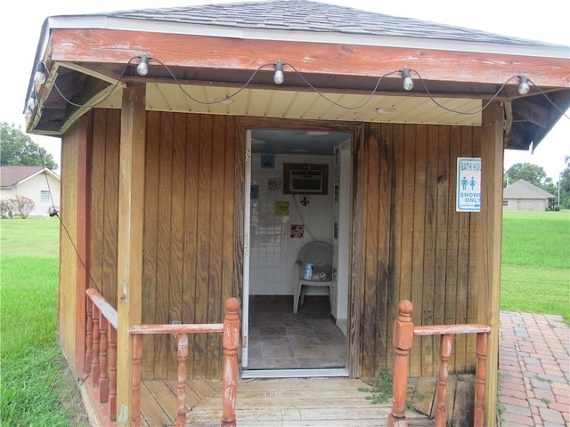 entrance to property featuring a lawn