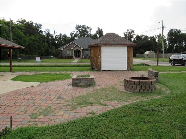 view of yard with a garage and an outbuilding