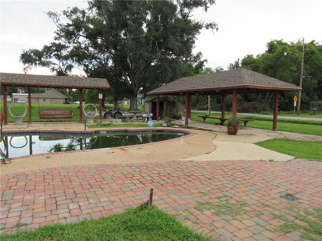 view of community featuring a patio, a gazebo, a yard, and a swimming pool