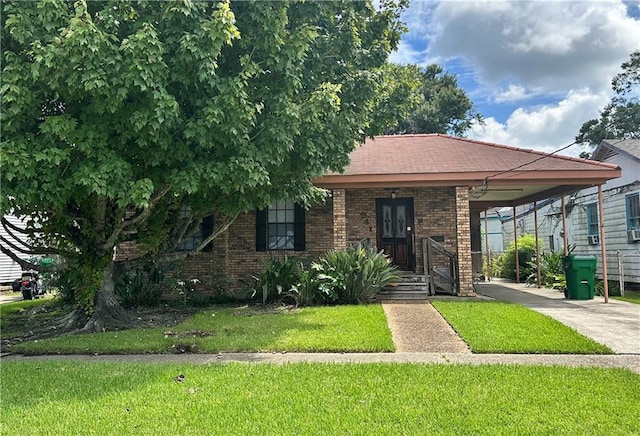 view of front of house with a carport and a front lawn