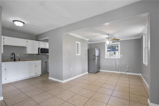 kitchen featuring sink, white cabinetry, appliances with stainless steel finishes, and light tile patterned floors