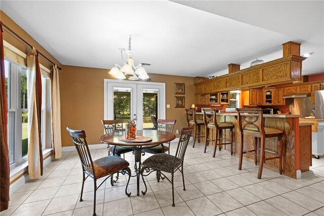 17 P M Hall Rd, Poplarville, MS 39470 - tiled dining space featuring french doors and a chandelier