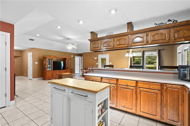 17 P M Hall Rd, Poplarville, MS 39470 - kitchen featuring butcher block counters, kitchen peninsula, light tile patterned floors, and ceiling fan