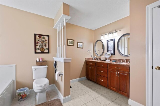17 P M Hall Rd, Poplarville, MS 39470 - bathroom featuring tile patterned flooring, a bathtub, toilet, and double sink vanity