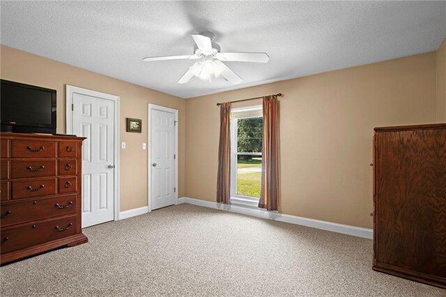 17 P M Hall Rd, Poplarville, MS 39470 - unfurnished bedroom featuring light carpet, multiple closets, a textured ceiling, and ceiling fan