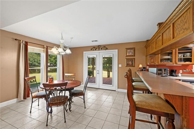 17 P M Hall Rd, Poplarville, MS 39470 - dining area featuring a notable chandelier, french doors, and light tile patterned floors
