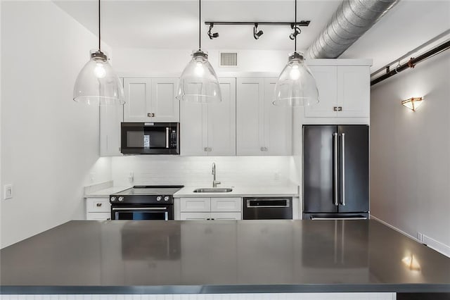 kitchen featuring black appliances, sink, pendant lighting, decorative backsplash, and white cabinetry