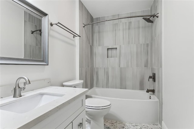 full bathroom featuring vanity, tiled shower / bath combo, and toilet