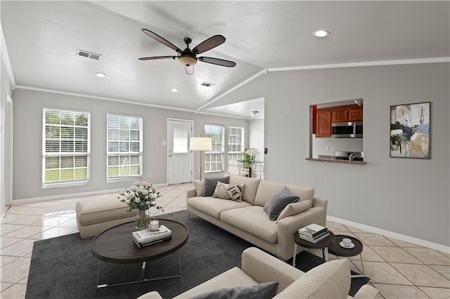 tiled living room featuring crown molding, vaulted ceiling, and ceiling fan