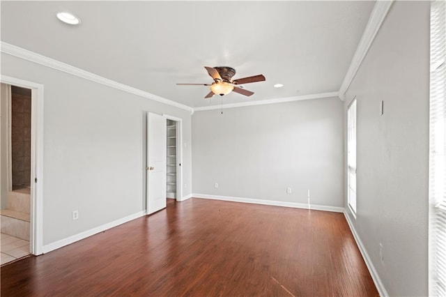 empty room featuring ornamental molding, a wealth of natural light, ceiling fan, and hardwood / wood-style floors