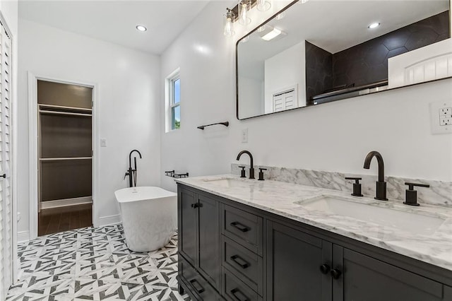 bathroom featuring dual vanity, a bath, and tile patterned floors