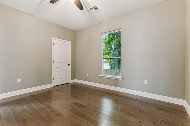 spare room with ceiling fan and dark hardwood / wood-style floors