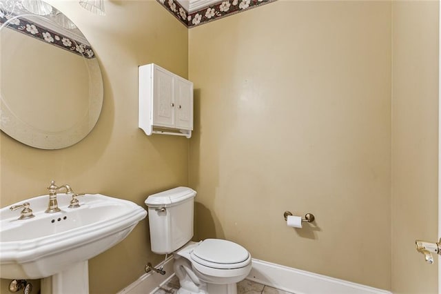 bathroom featuring sink, tile patterned flooring, and toilet