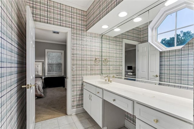 bathroom with tile patterned flooring, tile walls, vanity, and ornamental molding