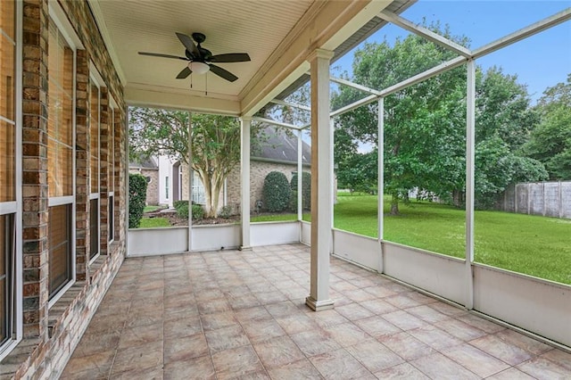 unfurnished sunroom featuring a healthy amount of sunlight and ceiling fan