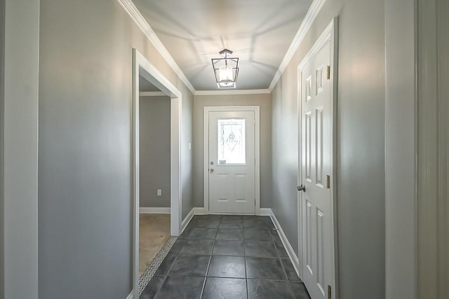 doorway to outside featuring crown molding and dark tile patterned flooring