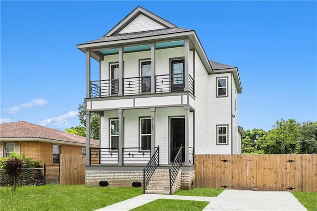 view of front of house with a balcony and a front yard