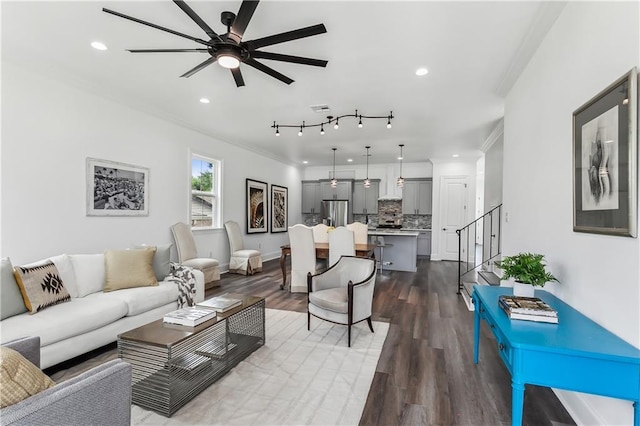 living room featuring hardwood / wood-style floors, ceiling fan, rail lighting, and ornamental molding