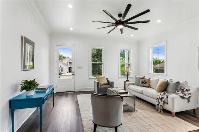 living room featuring crown molding, ceiling fan, and hardwood / wood-style floors