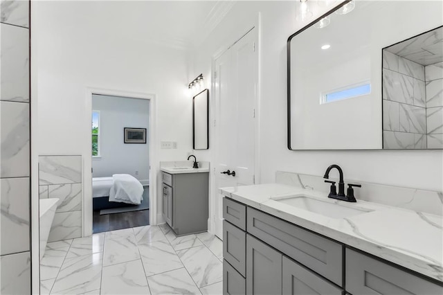 bathroom with ornamental molding, plenty of natural light, double sink vanity, and hardwood / wood-style floors