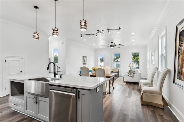 kitchen featuring stainless steel dishwasher, rail lighting, hardwood / wood-style floors, and an island with sink