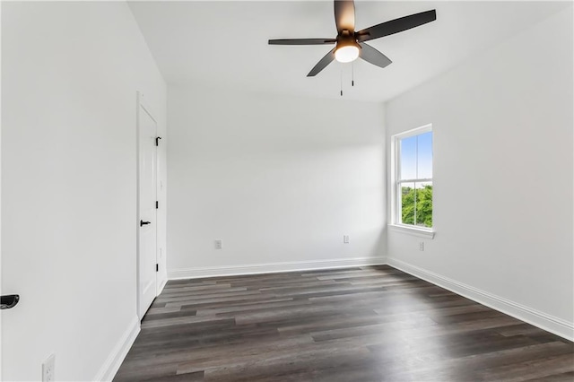 spare room with dark hardwood / wood-style flooring and ceiling fan